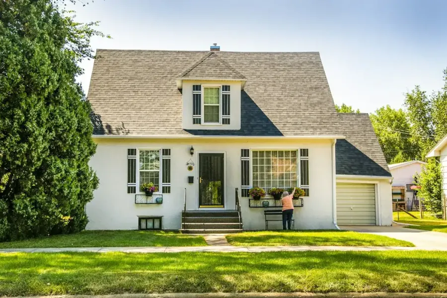 White story-and-a-half home with dormer windows on a Bismarck residential street